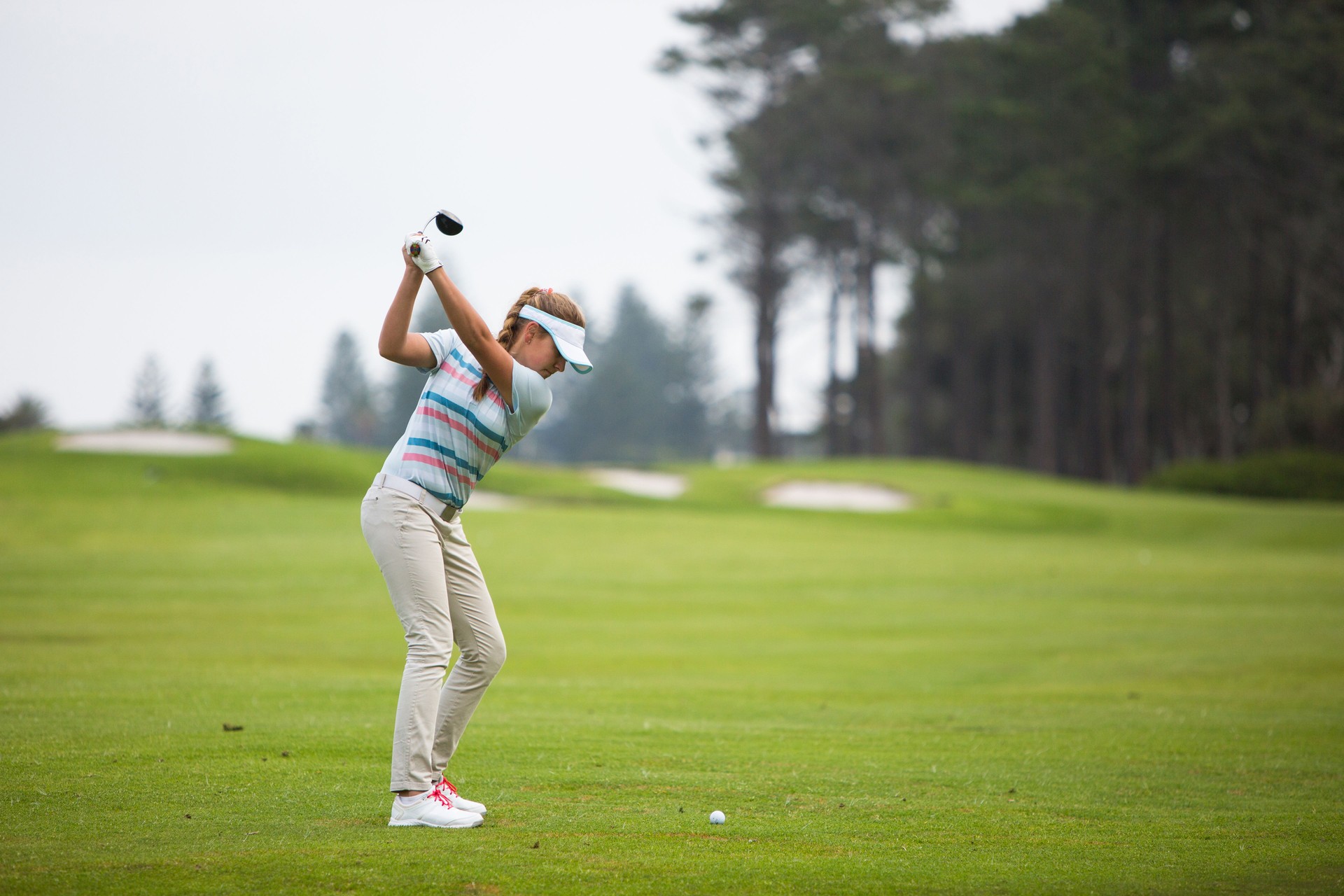 Perfect golf shot by a young female golfer