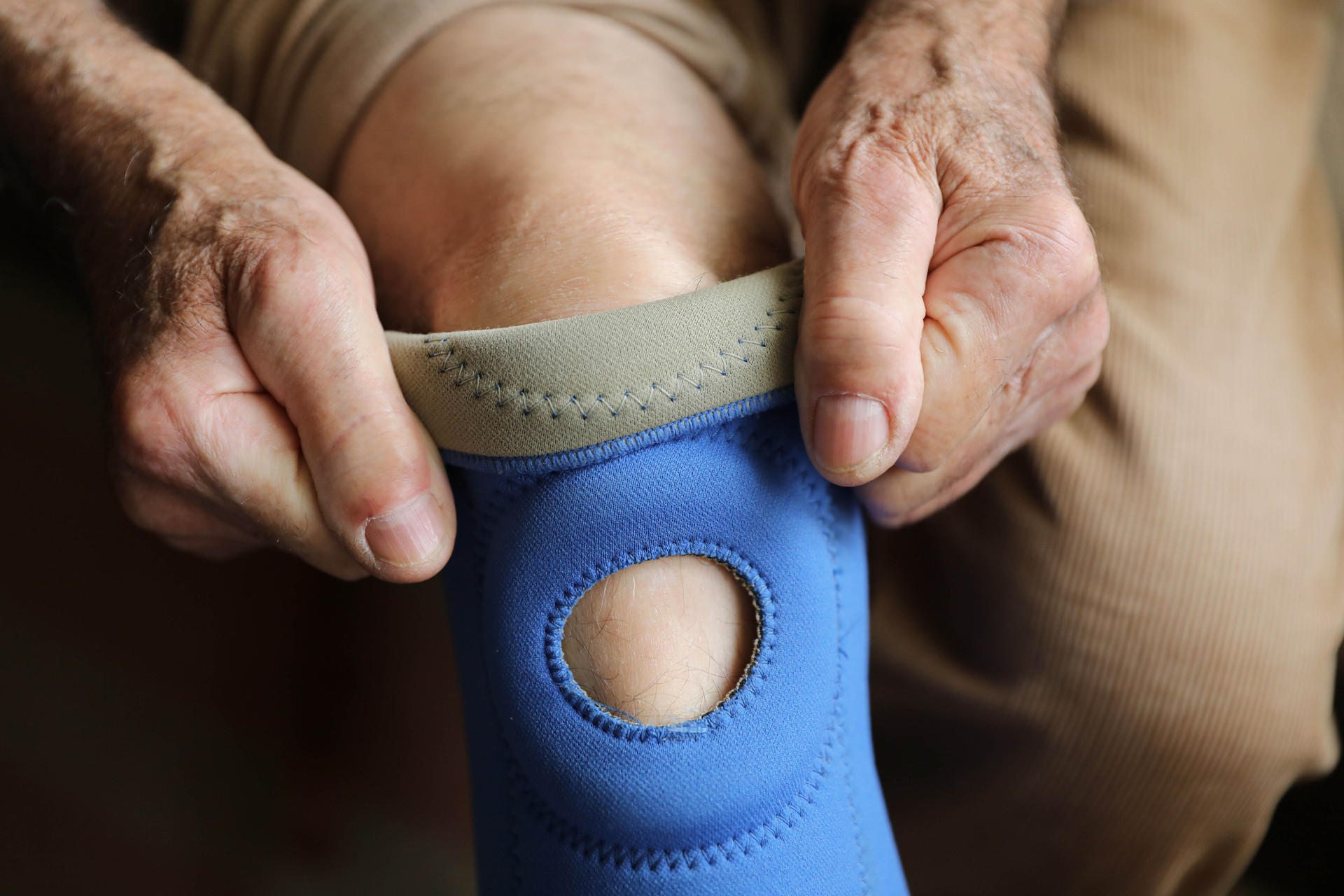 Man with brace on leg, knee injury